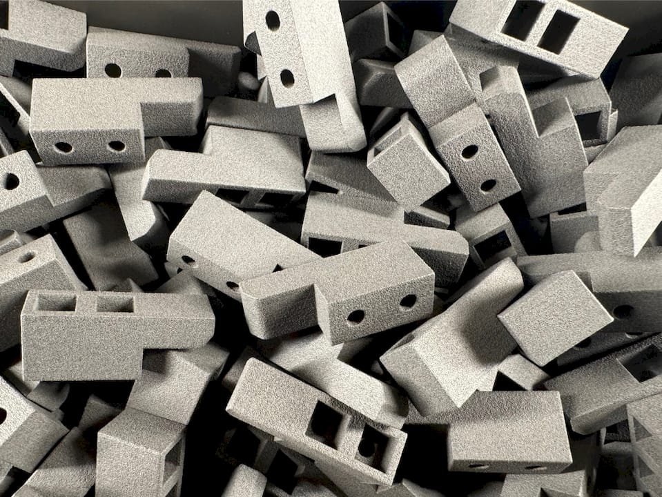 Un technicien intervient pour ajuster une imprimante 3D au sein d’une PME.